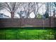 View of the front yard, including a brick wall and green lawn at 11907 Maria Ester Ct, Charlotte, NC 28277