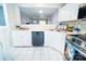 Well-appointed kitchen boasting white cabinets, tiled backsplash, and stainless steel dishwasher at 11907 Maria Ester Ct, Charlotte, NC 28277
