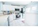 Well-lit kitchen featuring white cabinets, stainless steel appliances, and a tiled backsplash at 11907 Maria Ester Ct, Charlotte, NC 28277