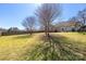 Expansive back yard featuring a well-maintained lawn and a wooden fence for added privacy at 125 Round Tuit Ln, Mt Ulla, NC 28125