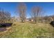 Large, private back yard enclosed by a wooden fence, offering ample outdoor space at 125 Round Tuit Ln, Mt Ulla, NC 28125