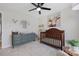 This Bedroom features a ceiling fan, carpeted floors, and a changing table with a grey dresser at 125 Round Tuit Ln, Mt Ulla, NC 28125