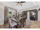 Formal dining room with elegant decor, wooden table, and large window overlooking the landscape at 125 Round Tuit Ln, Mt Ulla, NC 28125
