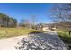 Long driveway with an attached two car garage and a well-kept lawn at 125 Round Tuit Ln, Mt Ulla, NC 28125