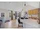 Bright kitchen with a quartz countertop island, stainless steel sink, and modern pendant lighting at 125 Round Tuit Ln, Mt Ulla, NC 28125