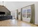 Bright living room with hardwood floors, a gray sofa, and lots of natural light at 125 Round Tuit Ln, Mt Ulla, NC 28125