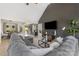 Spacious living room featuring a high ceiling, a large gray sofa, and a decorative media center at 125 Round Tuit Ln, Mt Ulla, NC 28125