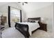 Main bedroom featuring a ceiling fan and a large arch window with dark curtains at 125 Round Tuit Ln, Mt Ulla, NC 28125