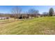 Spacious side yard with a gentle slope and verdant lawn, offering scenic views at 125 Round Tuit Ln, Mt Ulla, NC 28125