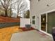 Backyard featuring a patio, sliding glass doors, partial fence, and professionally landscaped hill at 1365 Eagle Claw Dr, Kannapolis, NC 28083