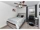 Cozy bedroom featuring a striped comforter and a desk next to the window at 1365 Eagle Claw Dr, Kannapolis, NC 28083