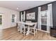 Dining room with a decorative accent wall and natural light from surrounding windows at 1365 Eagle Claw Dr, Kannapolis, NC 28083
