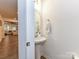 Well-lit powder room featuring a pedestal sink, stylish mirror, and modern fixtures at 1365 Eagle Claw Dr, Kannapolis, NC 28083