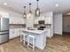 Modern kitchen with white cabinets, stainless steel appliances, and a center island at 1365 Eagle Claw Dr, Kannapolis, NC 28083