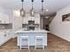 Bright kitchen featuring a center island with pendant lighting and white cabinetry at 1365 Eagle Claw Dr, Kannapolis, NC 28083