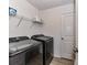 Laundry room with gray front load washer and dryer, wire shelving, and light wood flooring at 1365 Eagle Claw Dr, Kannapolis, NC 28083