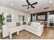Bright living room with a large sofa, dining area, and natural light from large windows at 1365 Eagle Claw Dr, Kannapolis, NC 28083