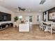 Open-concept living room with a large sofa, ceiling fan, and sliding glass doors at 1365 Eagle Claw Dr, Kannapolis, NC 28083