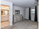Spacious main bedroom with a light wood dresser and an en-suite bathroom through the doorway at 1365 Eagle Claw Dr, Kannapolis, NC 28083