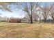 Spacious backyard featuring a brick home, enclosed porch and mature trees, ideal for outdoor enjoyment at 137 Dellinger Dr, Statesville, NC 28625