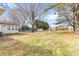 Expansive backyard view including the house, sunroom and storage sheds, all within a fenced perimeter at 137 Dellinger Dr, Statesville, NC 28625