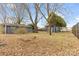 Fenced backyard featuring storage sheds and mature trees, providing ample space at 137 Dellinger Dr, Statesville, NC 28625