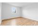 Bright bedroom features hardwood floors and a window letting in natural light at 137 Dellinger Dr, Statesville, NC 28625