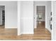 Bright entryway featuring wood-look flooring and white trim, leading to other rooms in the home at 137 Dellinger Dr, Statesville, NC 28625