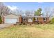 Charming brick ranch home with an attached garage and a well-maintained front yard with mature landscaping at 137 Dellinger Dr, Statesville, NC 28625