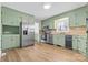 Spacious kitchen with stainless steel appliances and green cabinets, offering ample counter space at 137 Dellinger Dr, Statesville, NC 28625