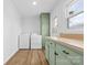 Functional laundry room featuring side by side washer and dryer plus a folding table and cabinets at 137 Dellinger Dr, Statesville, NC 28625
