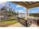 Inviting back porch with lake view featuring swing and black metal railing at 14021 Queens Harbor Rd, Charlotte, NC 28278