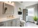 This bright bathroom offers a light color scheme, cabinetry, and fresh plants at 14021 Queens Harbor Rd, Charlotte, NC 28278
