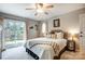 Comfortable bedroom with a ceiling fan and access to the outdoor patio area at 14021 Queens Harbor Rd, Charlotte, NC 28278