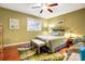 Green bedroom with wood floors, a ceiling fan, and a stylish rug at 14021 Queens Harbor Rd, Charlotte, NC 28278