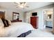 This bedroom features a flat screen TV, dresser, and access to the bathroom at 14021 Queens Harbor Rd, Charlotte, NC 28278