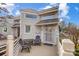 Exterior view showing an entryway and porch with chairs and a table, perfect for enjoying outdoor moments at 14021 Queens Harbor Rd, Charlotte, NC 28278
