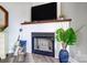 Close up of a modern fireplace with decorations and wood flooring at 14021 Queens Harbor Rd, Charlotte, NC 28278