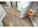 Hallway features wood-look floors that lead to the kitchen and staircase at 14021 Queens Harbor Rd, Charlotte, NC 28278