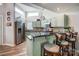 Charming kitchen with stainless steel appliances, stone countertops, and a breakfast bar with seating at 14021 Queens Harbor Rd, Charlotte, NC 28278