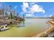 Panoramic lake view with docks and lush landscaping, perfect for relaxation at 14021 Queens Harbor Rd, Charlotte, NC 28278