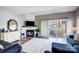 Comfortable living room with a fireplace, flatscreen tv, and sliding glass doors to an outdoor patio at 14021 Queens Harbor Rd, Charlotte, NC 28278