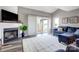 Cozy living room featuring a fireplace, flatscreen TV, plush seating, and access to outdoor patio at 14021 Queens Harbor Rd, Charlotte, NC 28278