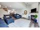 Open concept living room with fireplace, eat-in kitchen, plush seating and wood flooring at 14021 Queens Harbor Rd, Charlotte, NC 28278