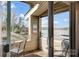 Covered outdoor patio with seating and a view of the lake at 14021 Queens Harbor Rd, Charlotte, NC 28278
