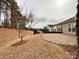 View of the stone patio that opens to a large side yard with mature trees at 2023 Moultrie Ct, Fort Mill, SC 29707
