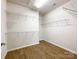 Walk-in closet featuring hardwood floors and wire rack shelving on the surrounding walls at 2023 Moultrie Ct, Fort Mill, SC 29707