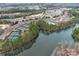 Aerial view of the community showcases wooded areas, lake, pool, tennis courts, and golf course at 2023 Moultrie Ct, Fort Mill, SC 29707