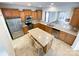 Open kitchen with stainless steel appliances, tile backsplash, island, and ample cabinet space at 2023 Moultrie Ct, Fort Mill, SC 29707