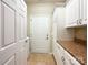 Laundry room featuring tile flooring and white cabinets with a brown countertop at 2023 Moultrie Ct, Fort Mill, SC 29707
